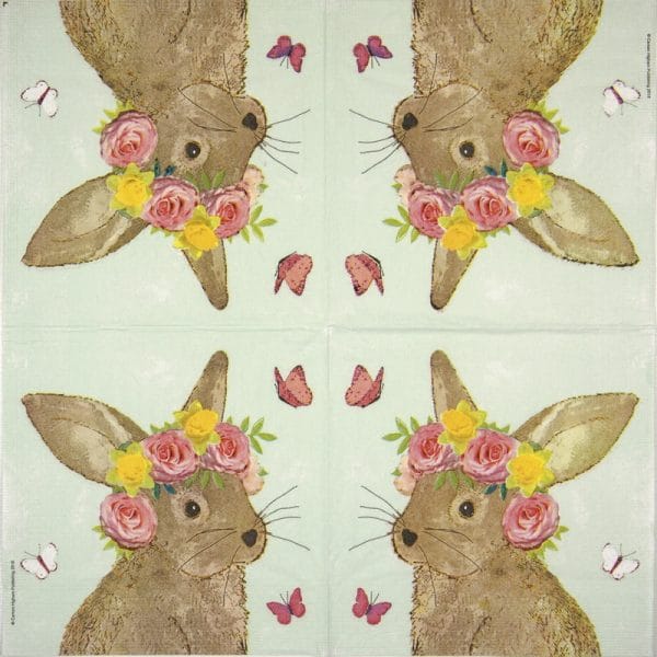 Paper napkin Easter bunny head with flowers on green background