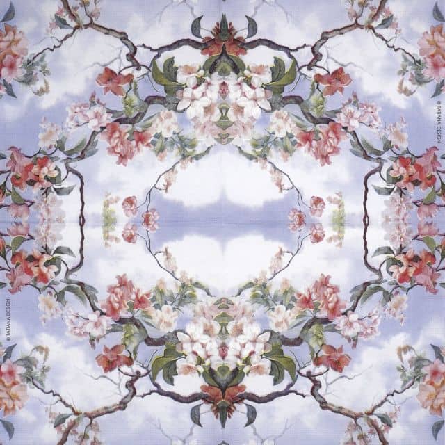 Full view of PPD Equador napkin – symmetrical floral design with cherry blossoms and curved branches on a pastel sky