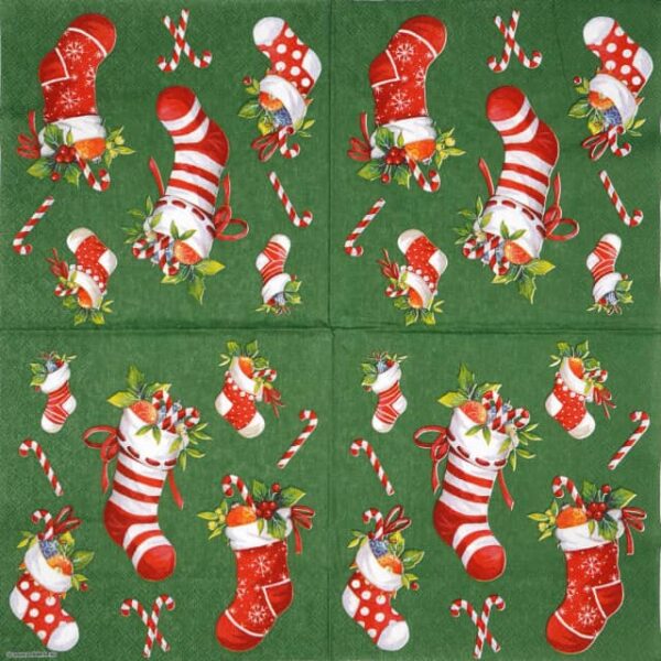 Festive Christmas decoupage napkin featuring a playful arrangement of red and white patterned Christmas stockings filled with candy canes and holly, interspersed with individual candy canes, all on a vibrant green background. Unfolded napkin.