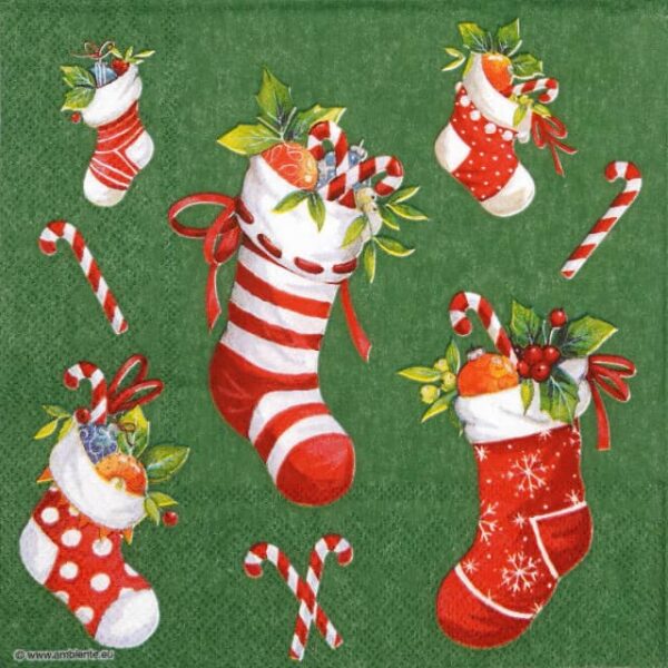 Quarter of a festive napkin featuring red and white patterned Christmas stockings filled with candy canes and holly, scattered with candy canes on a clean green background. Perfect for decoupage.