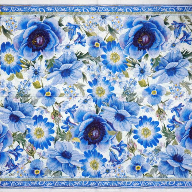 Full napkin layout featuring a repeated pattern of blue and purple blossoms with green foliage on a white background.