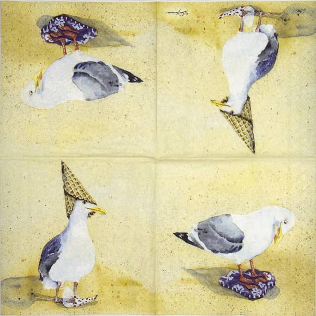 Decoupage napkin featuring four whimsical illustrations of seagulls on a beach-colored background. One seagull is laying down, one is wearing an ice cream cone hat, and another is on a purple tile.